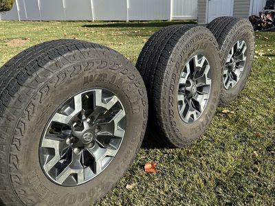Four Tacoma TRD Off-Road Wheels And Three Tires