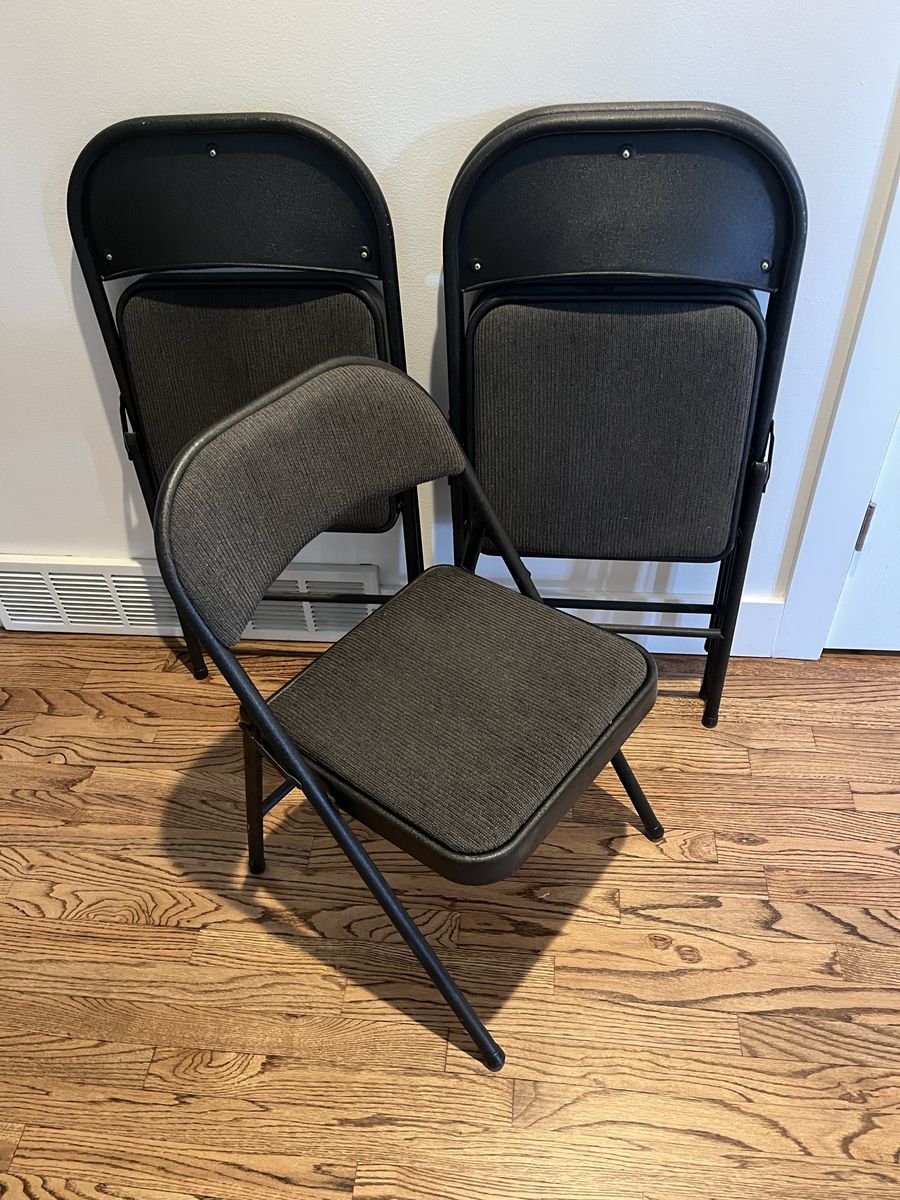 Black folding chairs w fabric cushions