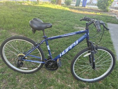 blue Huffy Rock Creek mountain bike, featuring 26-inch wheels and a steel frame.