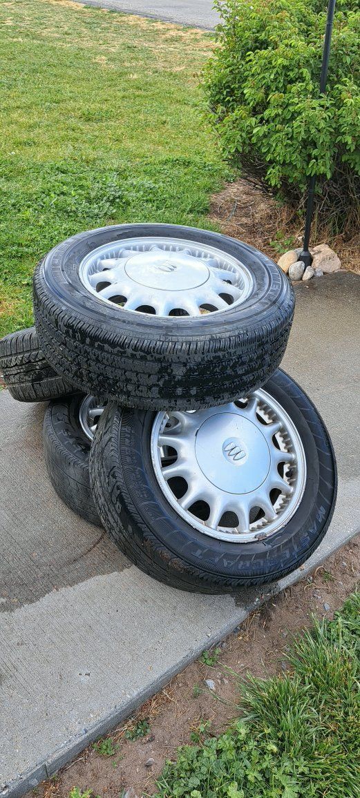 4 aluminum wheels with used tires