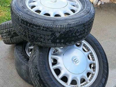 4 aluminum wheels with used tires