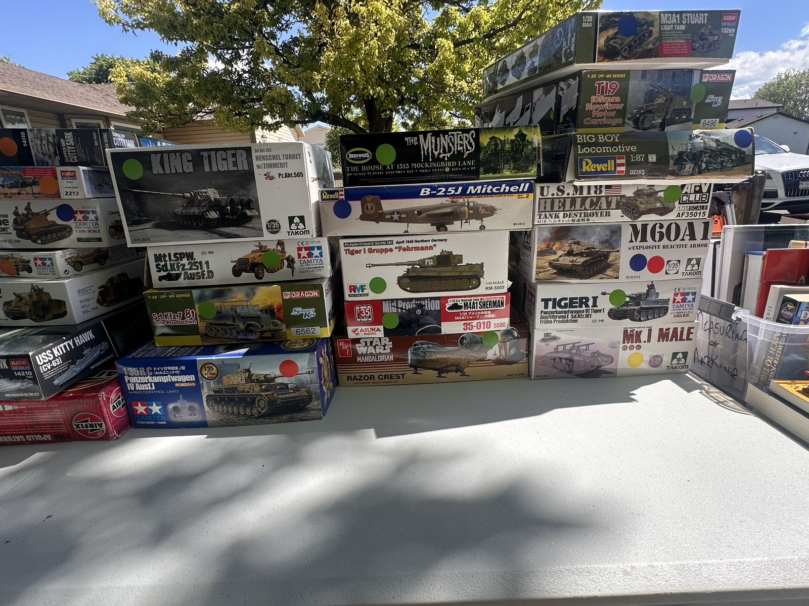 Various scale model kits, airbrush, and paints.