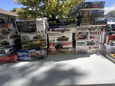 Various scale model kits, airbrush, and paints.