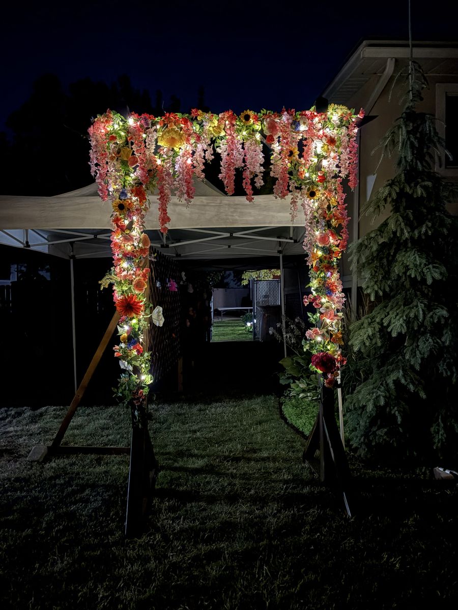 Wooden Wedding Arch With Flowers and Lights