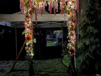 Wooden Wedding Arch With Flowers and Lights