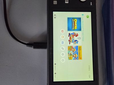 Grey nintendo switch with charger and Mario game 180