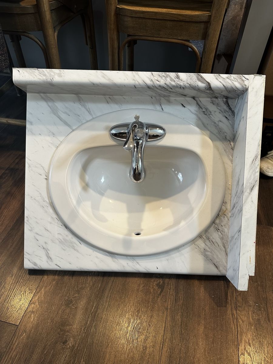 Laminate Vanity Top and Integrated Sink and Faucet with White Calcutta Marble design