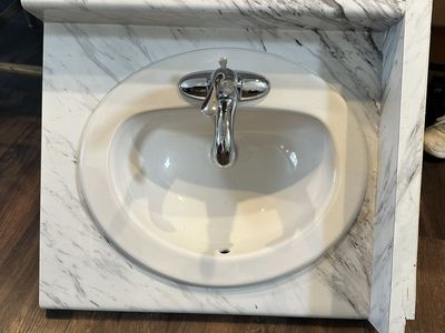 Laminate Vanity Top and Integrated Sink and Faucet with White Calcutta Marble design