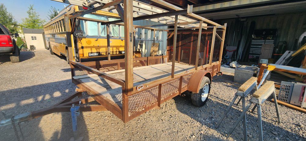 Single-Axle Utility Trailer with Built-in Ladder Rack and Wood Deck