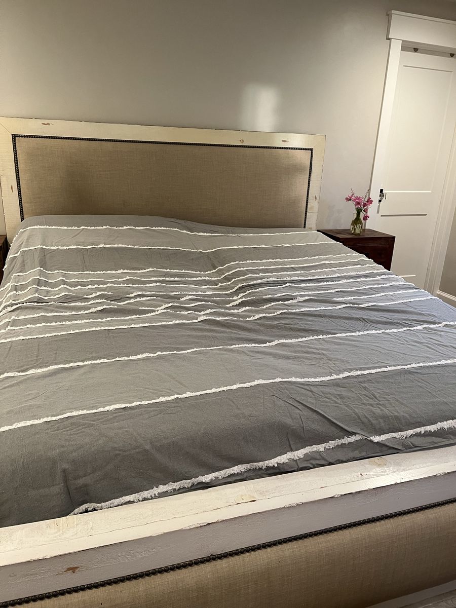 California King Bed frame. Distressed white with upholstery. And dresser to match.
