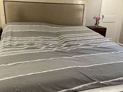 California King Bed frame. Distressed white with upholstery. And dresser to match.