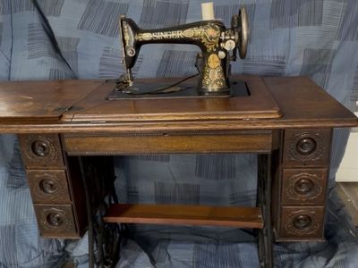 Antique Singer Electric Sewing Machine with Ornate Cabinet and Iron Stand
