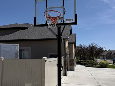 Adjustable basketball standard and hoop