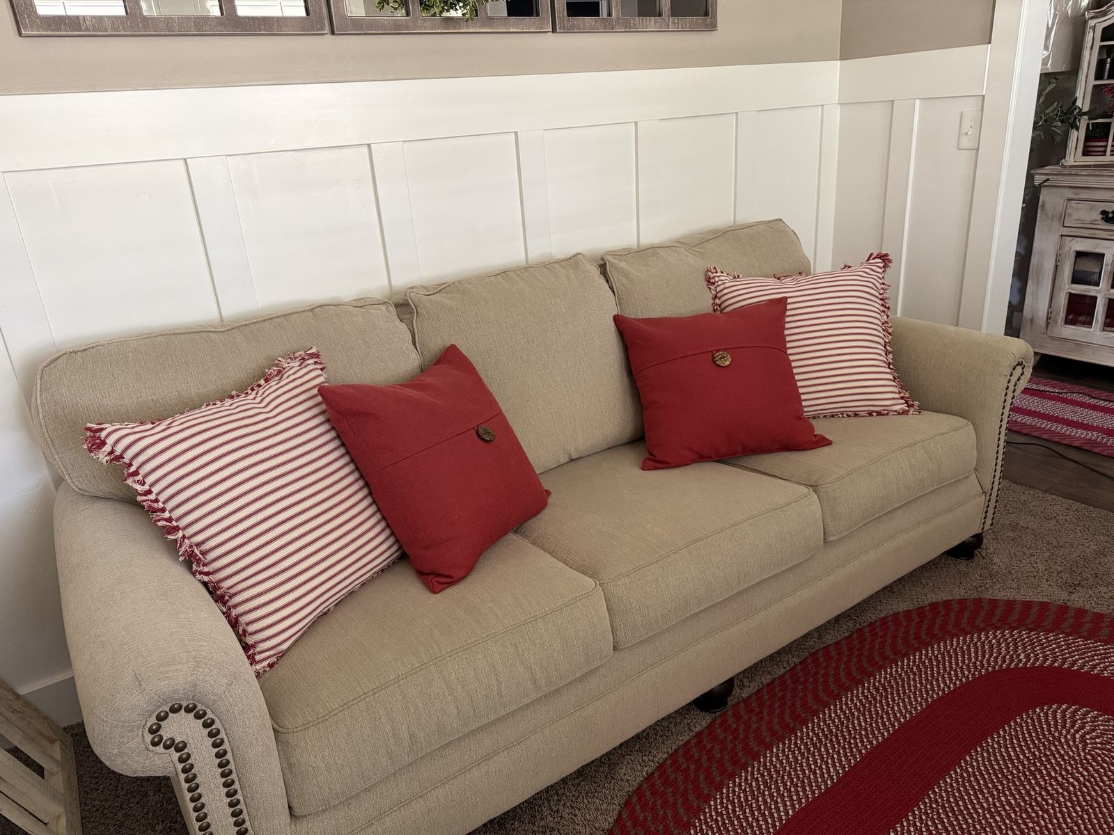 Beige Fabric Sofa with Nailhead Trim and Decorative Pillows