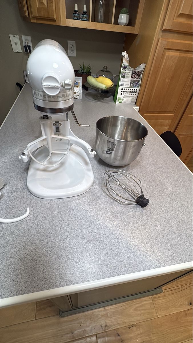 White KitchenAid Heavy Duty Stand Mixer with Bowl and Attachments