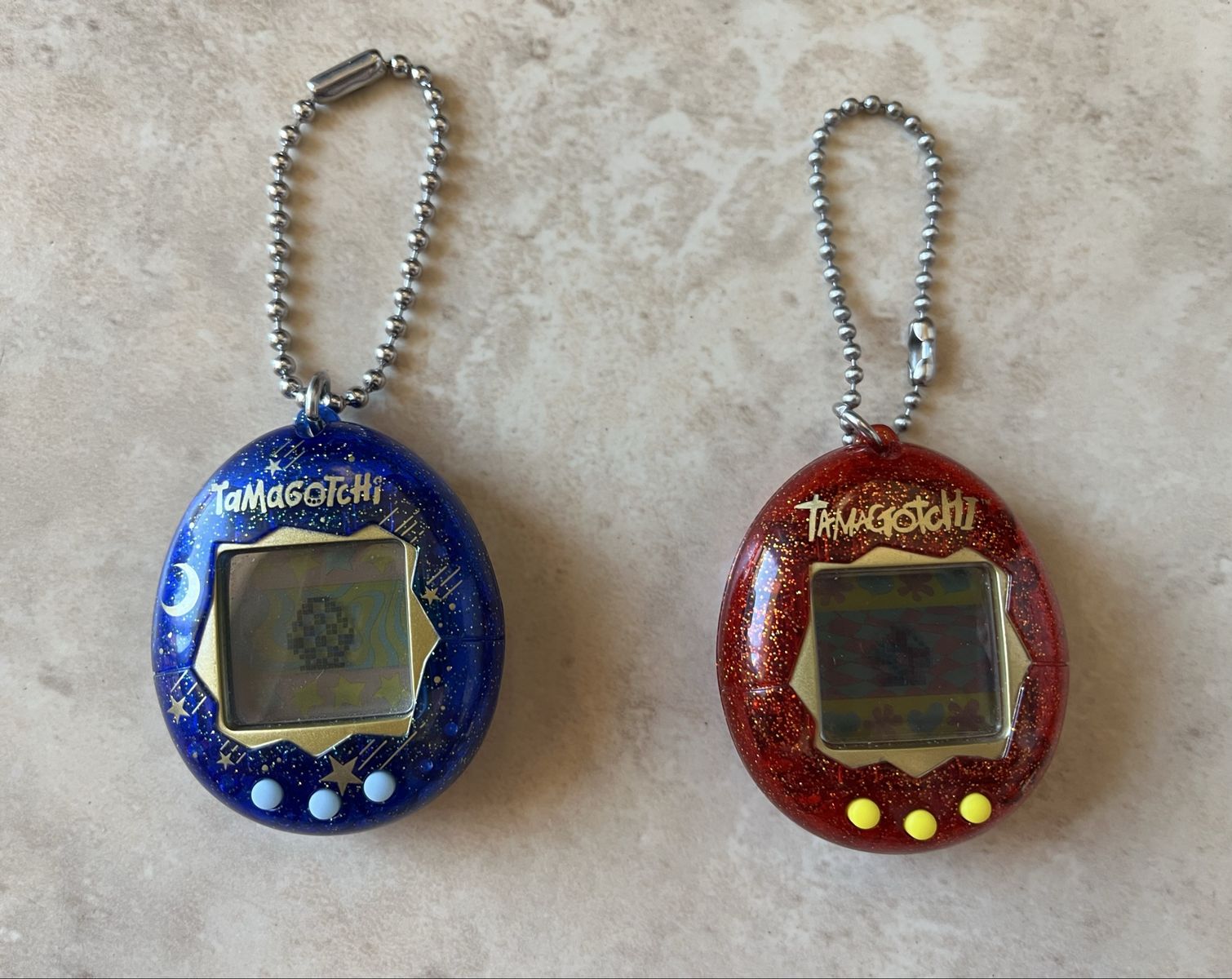 2 Tamagotchi Digital Pets- Blue Starry Shower and Red Glitter