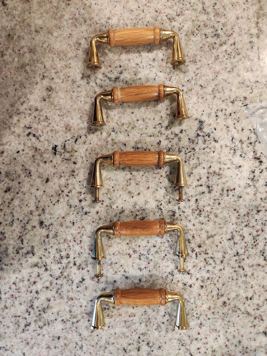Five gold and wood drawer pulls
