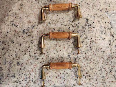 Five gold and wood drawer pulls