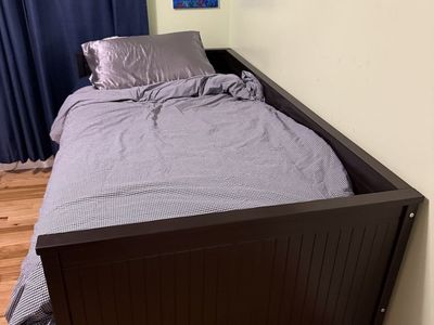 Dark Wood Daybed with Three Under-Bed Storage Drawers. Twin when day bed is tucked away.