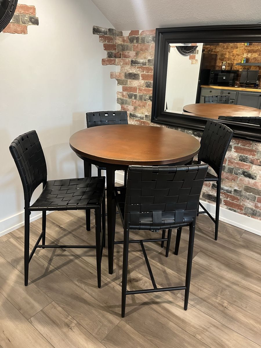 Round Pub Table with Four Woven Black Leather Bar Stools
