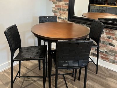 Round Pub Table with Four Woven Black Leather Bar Stools