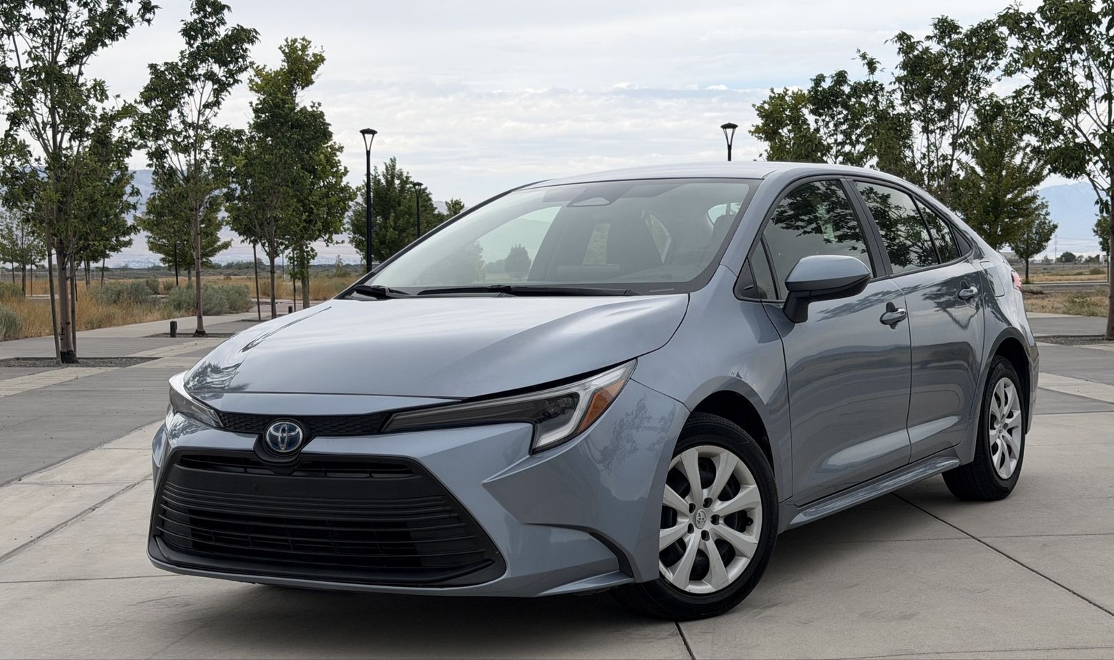 2023 Toyota Corolla Hybrid LE — rebuilt & branded title, 26% below market