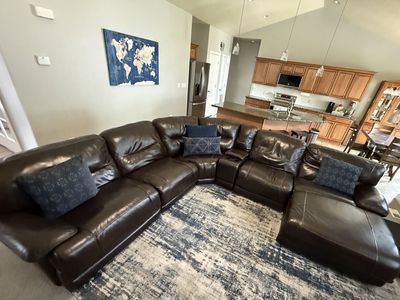 Comfortable 7-Piece Brown Leather Sectional with Recliners and Console with Cupholders