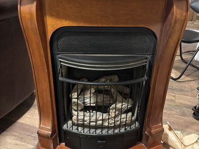Indoor Gas Fireplace with Wood Mantel Cabinet and Faux Logs