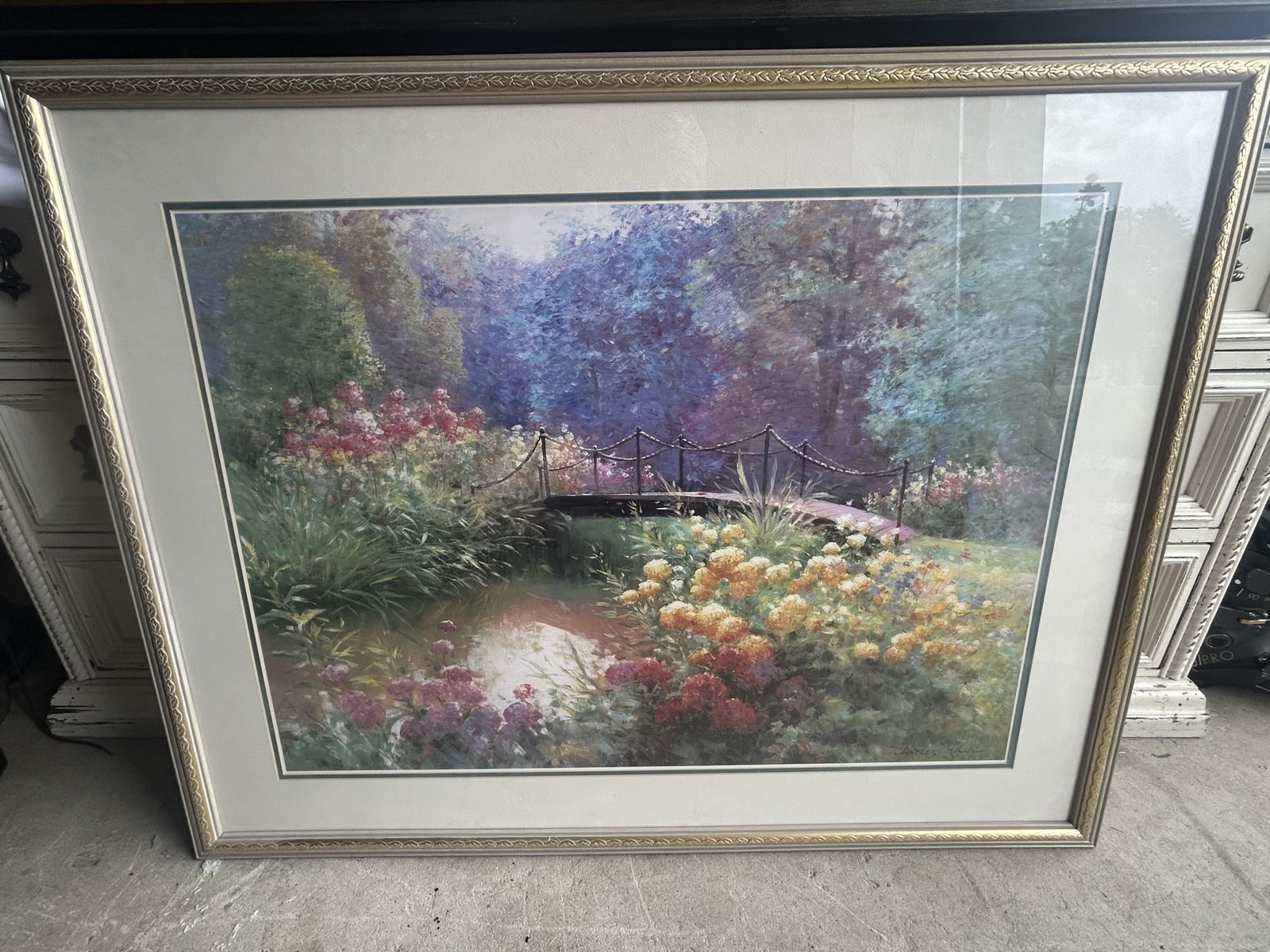 Framed Print Titled "Millbrook Crossing" by artist Charles Zhan, featuring a garden scene with a bridge over a pond.