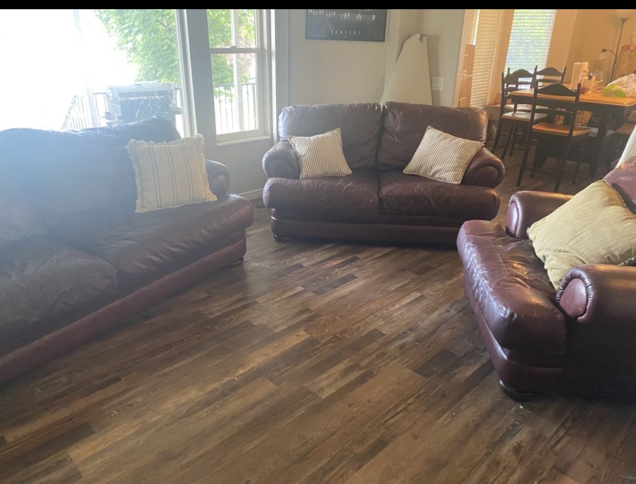 Burgundy Leather Sofa ottoman with Torn Cushion Seam Needs Repair