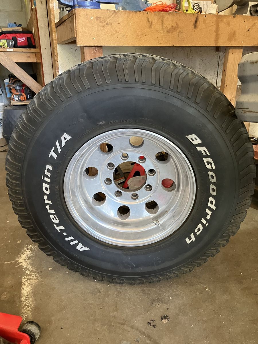 Dodge 35 12.50 8 lug rims and tires for sale.