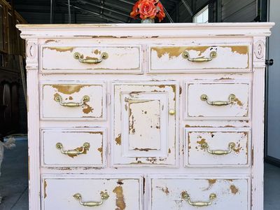 Distressed Light Pink Wooden Dresser with Brass Handles and Center Cabinet
