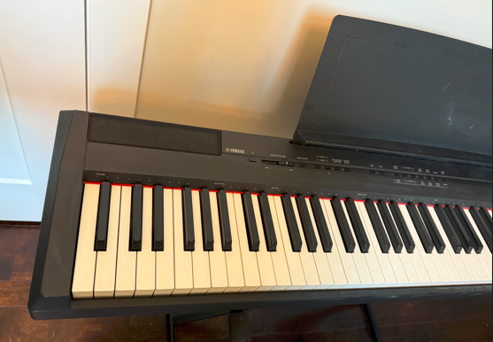 Yamaha P115 88-Key Weighted Action Digital Piano/keyboard with Sustain Pedal, music rest, and stand.