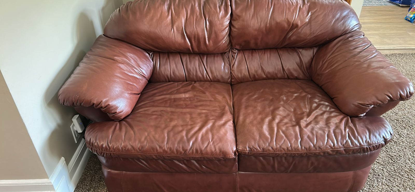 Brown leather loveseat