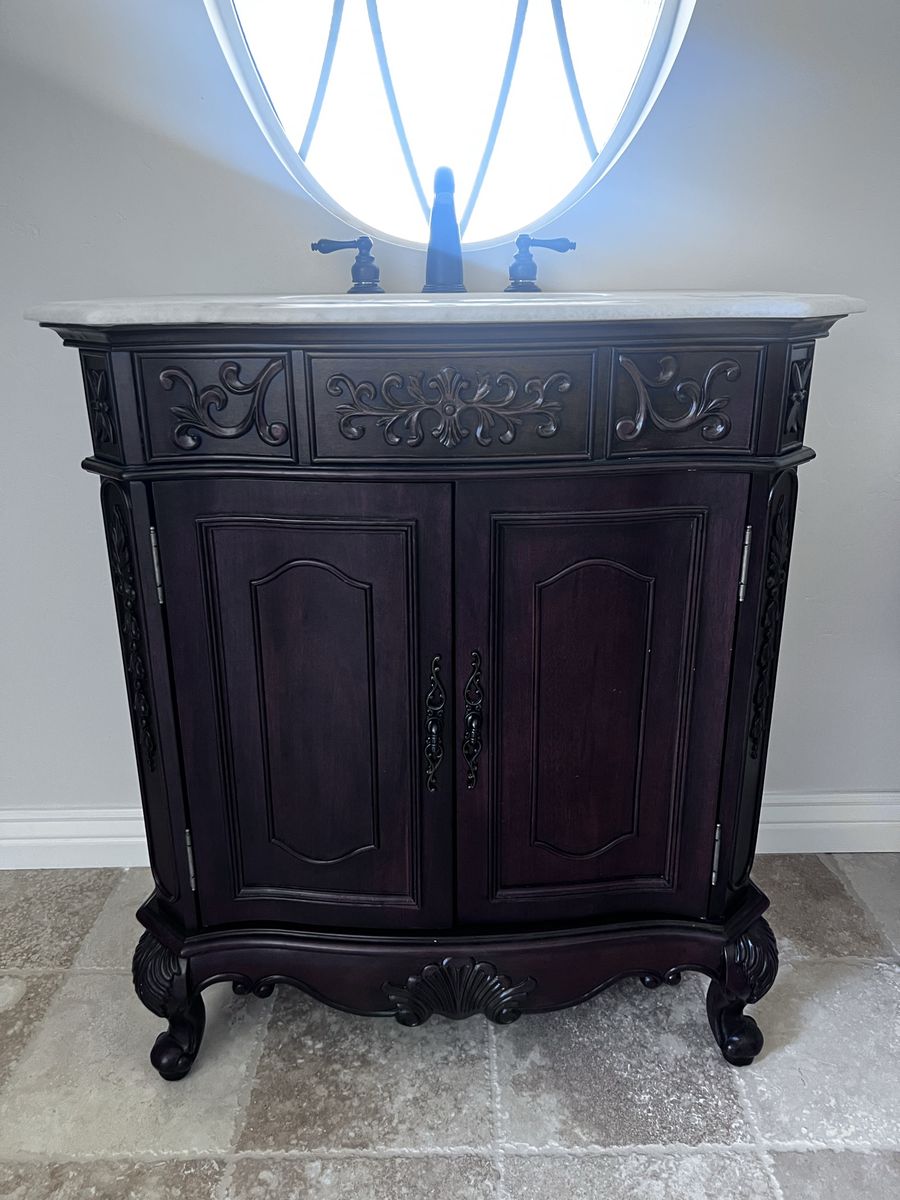 Ornate Dark Wood Bathroom Vanity with Marble Top and Faucet