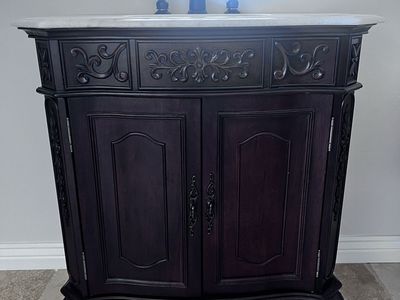 Ornate Dark Wood Bathroom Vanity with Marble Top and Faucet