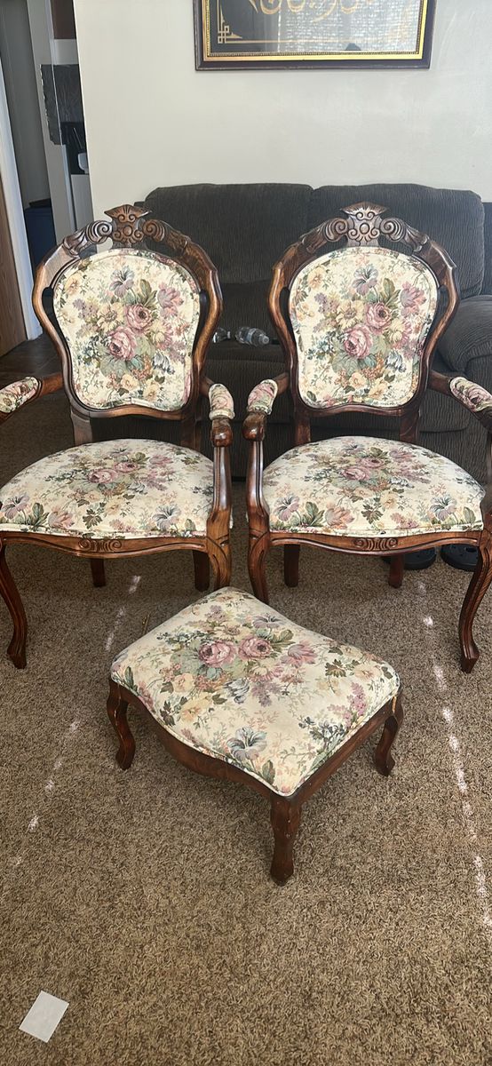 Two chairs and a foot stand