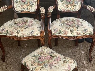 Two chairs and a foot stand