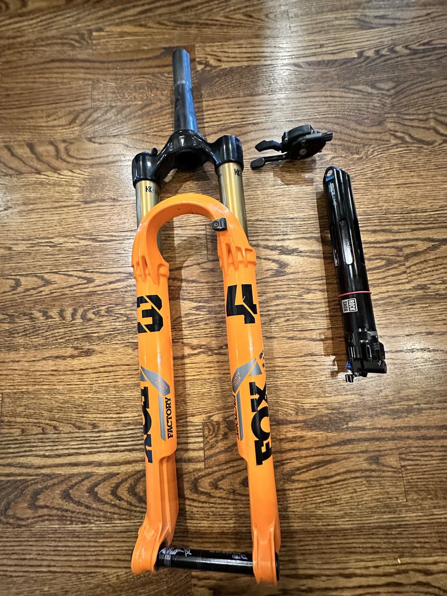 FOX 34 Factory fork and RockShox isostrut includes Remote Lockout
