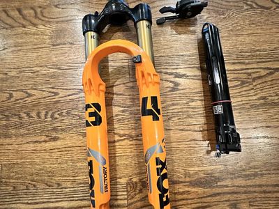 FOX 34 Factory fork and RockShox isostrut includes Remote Lockout