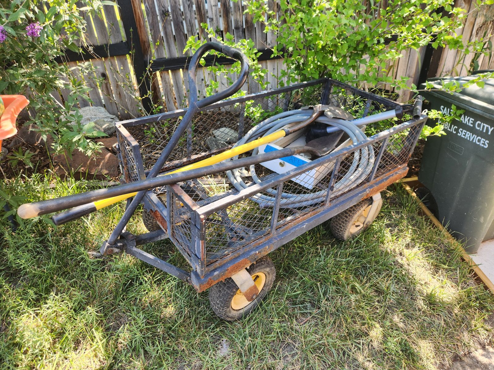 Heavy duty gardening cart.  All steel. Can carry hundreds of pounds.  Inflatable tires.  Can open the panels or remove them.