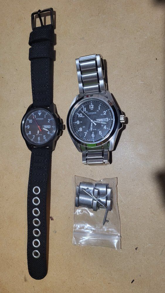 Two Citizen Eco-Drive Field Watches - Black Canvas & Stainless Steel Bands, Day/Date Display