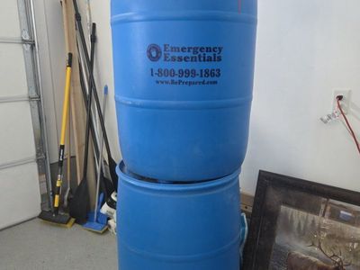 2 Emergency Essentials 55-Gallon Blue Plastic Water Storage Barrels Drums. used for water and stored in the garage.