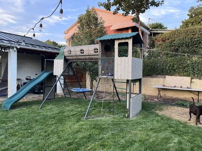 Lifetime Outdoor Playset with Slide, Crawl Tunnel, Rock Wall, and Saucer Swing