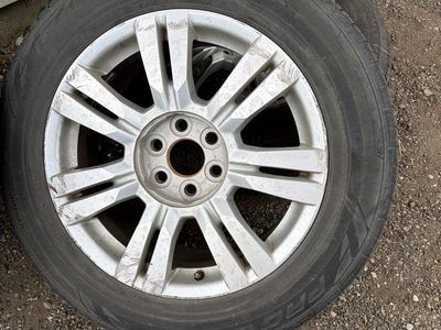 Cadillac STX Used 235/65R18 Tires on Silver Aluminum Wheels - Good Tread