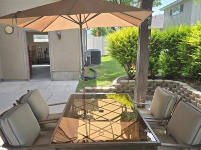 Patio Dining Set with Umbrella - Glass Table & 4 Cushioned Chairs and a chase lounge