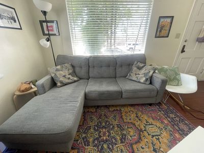 IKEA blue grey couch with decorative pillows