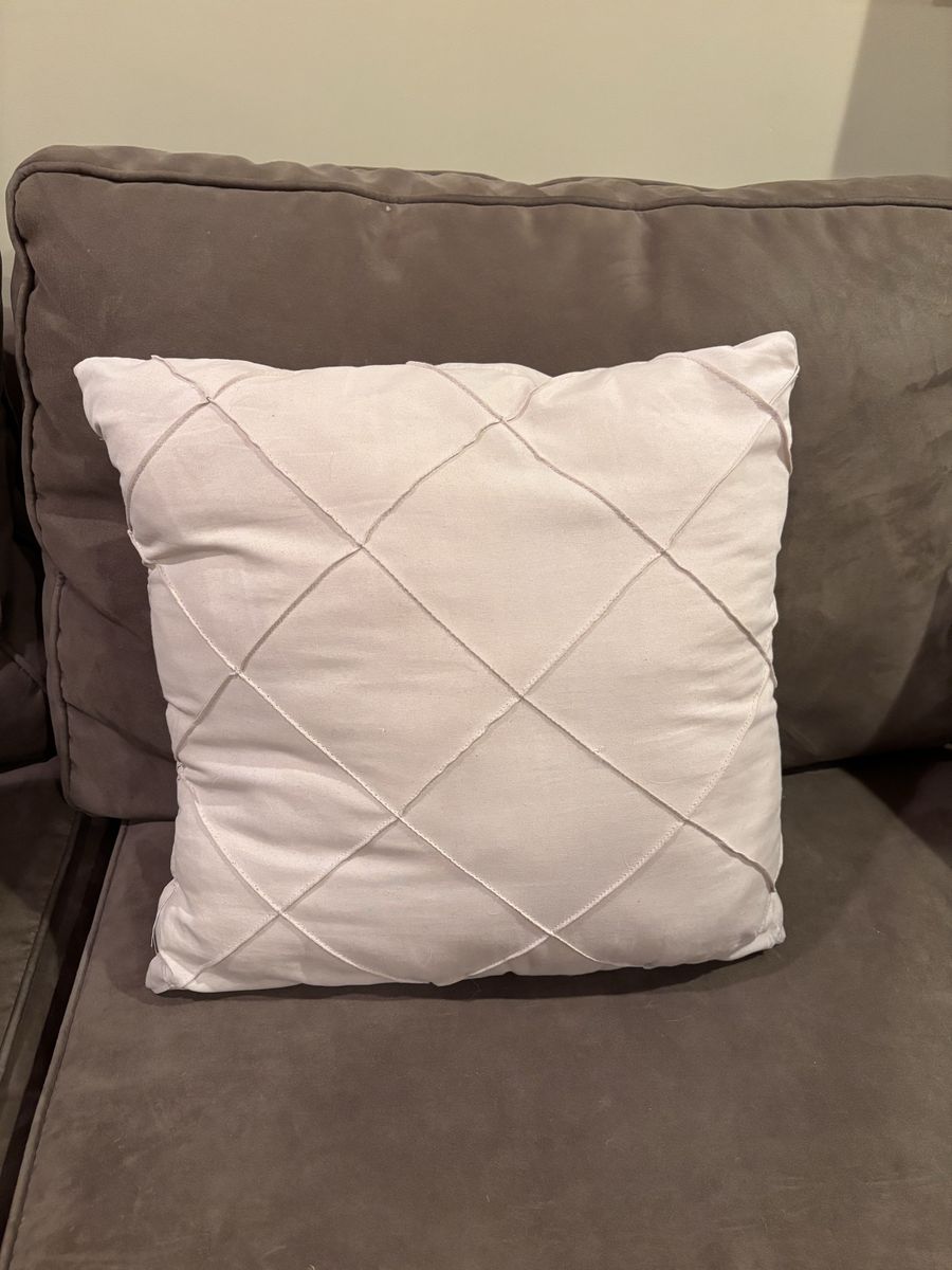 Cream color throw pillow.