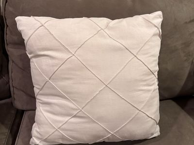 Cream color throw pillow.