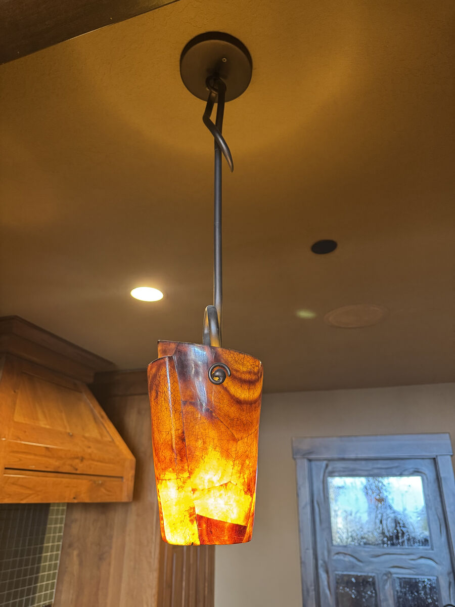 Pair of pendant lights features a handcrafted resin shade